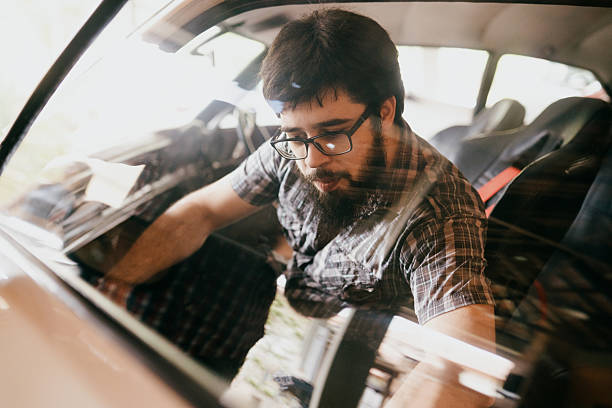 istock Focused car enthusiast checking interior details 2241915299