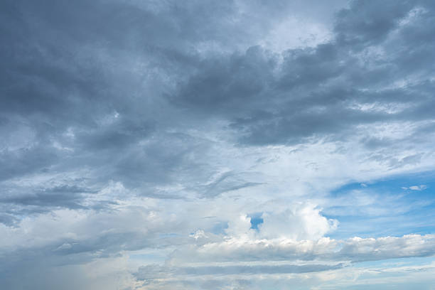 istock Overcast sky featuring dense gray storm clouds contrasted with patches of bright blue sky below 2241917313