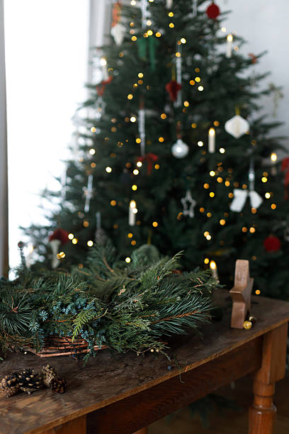 istock Making Christmas wreath. Christmas wreath with fir, pine and cedar branches, scissors and rustic star on wooden table on background of stylish xmas tree. Winter holidays preparation and decor 2241923146
