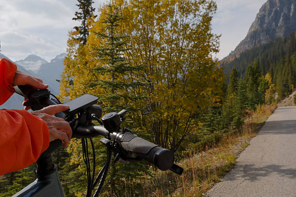 istock Woman touches digital screen on e-bicycle in mountains 2241933004