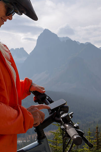 istock Woman touches digital screen on e-bicycle in mountains 2241933005