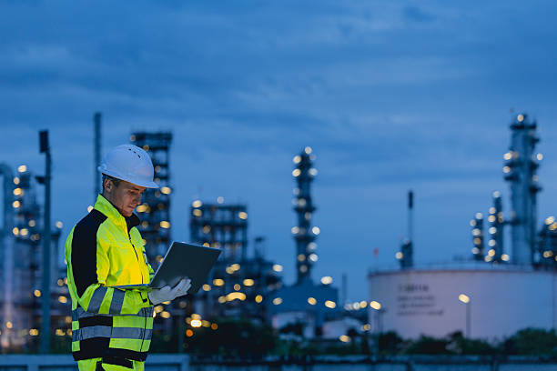 istock Professional Night shift engineer oil and gas refinery service, male worker hard work in petroleum industry plant dark background. 2241934175