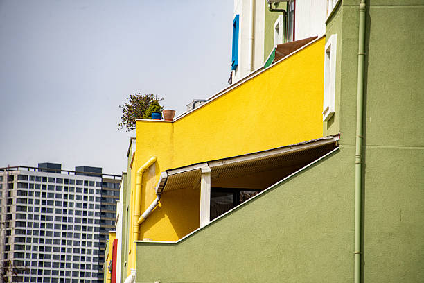 A tall tower and a colorful villa in the background