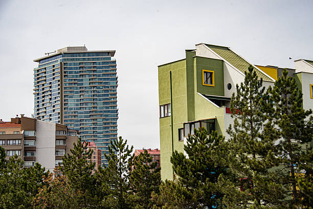A tall tower and a colorful villa in the background