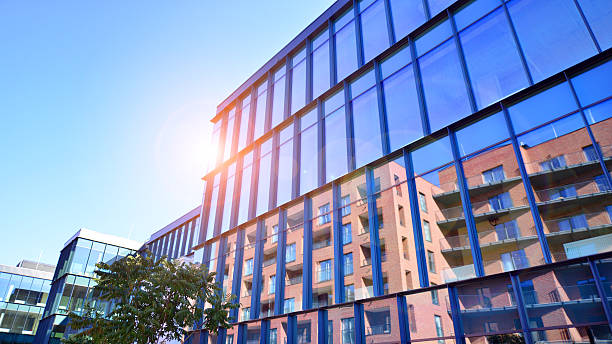istock Exterior of modern building with many windows against blue sky, low angle view. 2241943669