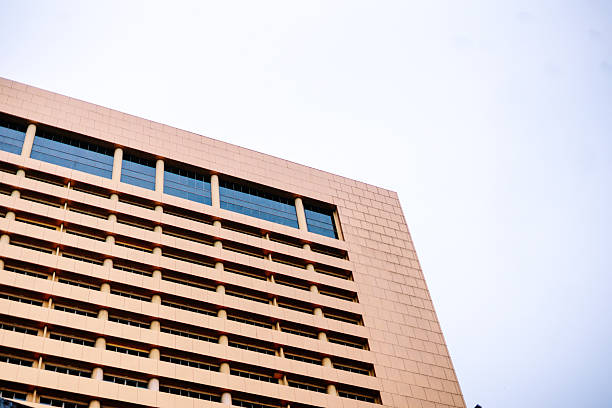istock Modern Building Facade with Rows of Windows Against Bright Sky 2241948804