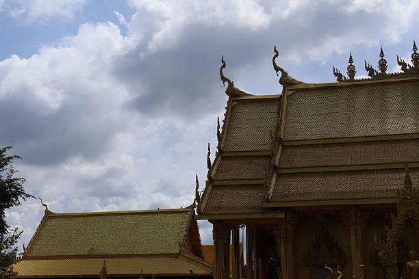 istock Golden temple architecture under cloudy sky, intricate design details highlighted, serene atmosphere, ideal for cultural themes. 2241949205