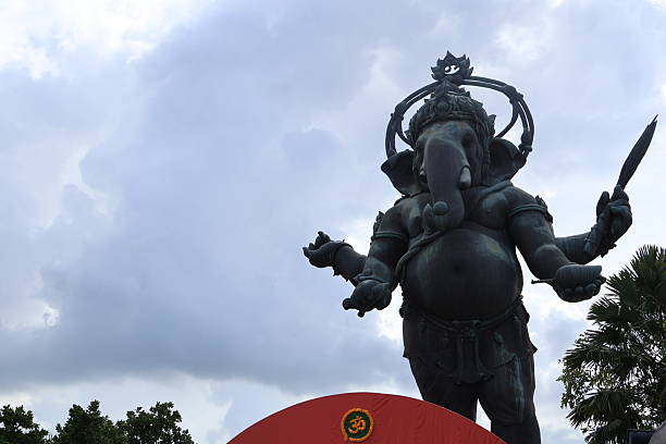 Dynamic warrior statue in action pose, detailed armor and weaponry, surrounded by lush greenery, perfect for historical themes.