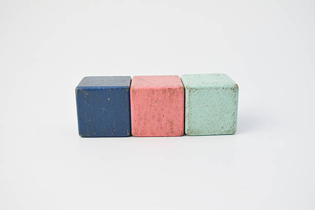 istock Three colorful cubes in blue, pink, and green placed side by side on white background, minimal composition symbolizing learning, creativity, or children's education concept. 2241950150