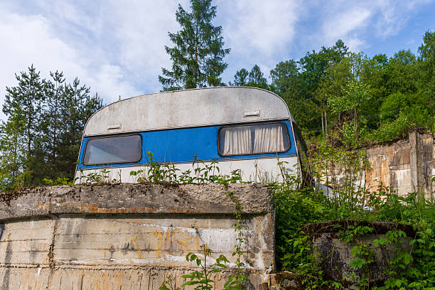 Retro styled image of a vintage caravan with towel and curtains