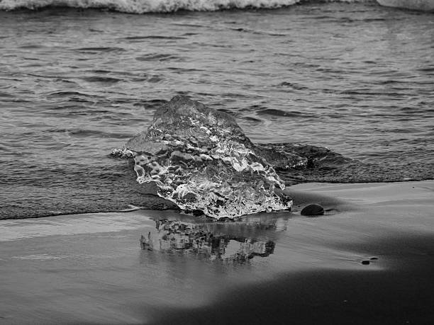 istock block of ice on black and volcanic sand 2241958482