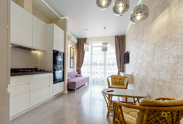 istock A modern living room with a white kitchen and a tan wall 2241969297