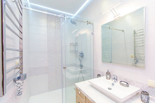 Bottom-up view of a closed bathroom door with a ceiling light on, toilet in an apartment