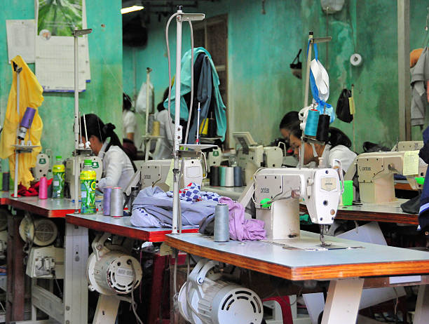 Hoi An, Quang Nam province, Vietnam: small textile factory in the old town,  with a front open to the street - Vietnam's textile and garment industry is a key economic driver, employing over 3 million workers across approximately 7,000 companies. Primary markets are the US, Japan, and South Korea.