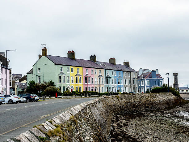 View of colourful houses at Beaumaris on Anglesey, UK. People can be seen on the promenade