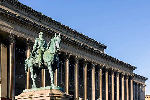 Glasgow, Scotland - People on a tour bus passing the statue of the Duke of Wellington with traffic cones on the Duke's head. The statue in Royal Exchange Square was completed by Carlo Marochetti in 1844, and complete with the cone has become an icon of the city.