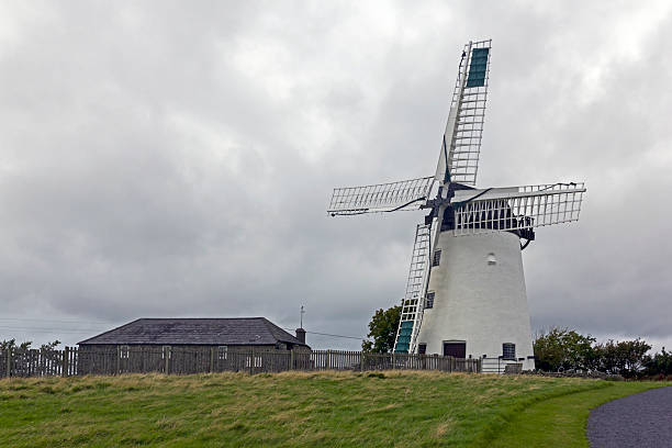3D rendering of wind mill above clouds