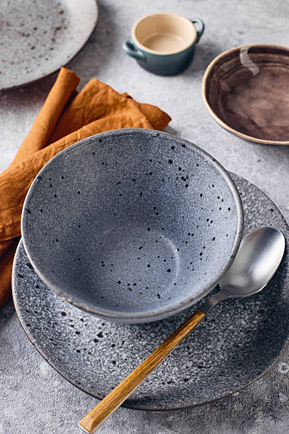istock Set of dinnerware with a spoon and a napkin. The table setting is simple and elegant 2241975377