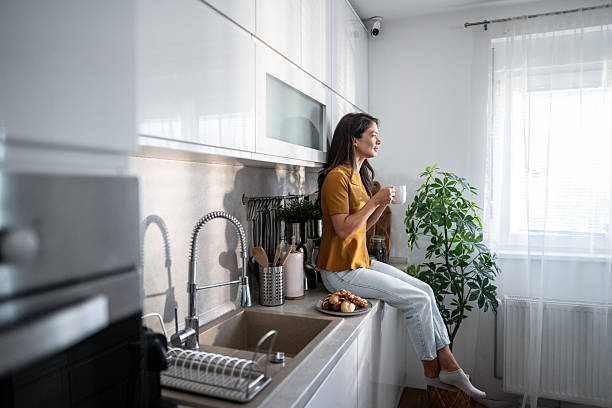 istock Woman drinking coffee in morning kitchen, enjoying relaxed moment 2241975698