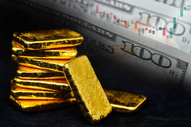 istock 100 dollar bill and gold bars with candlestick chart, investment concept 2241976348