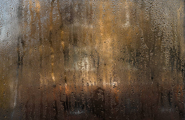 istock Wet glass window covered with tiny water droplets. 2241976879