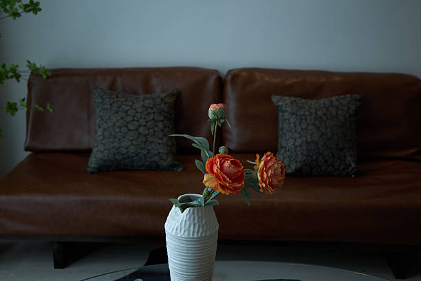 A vase in front of the leather sofa