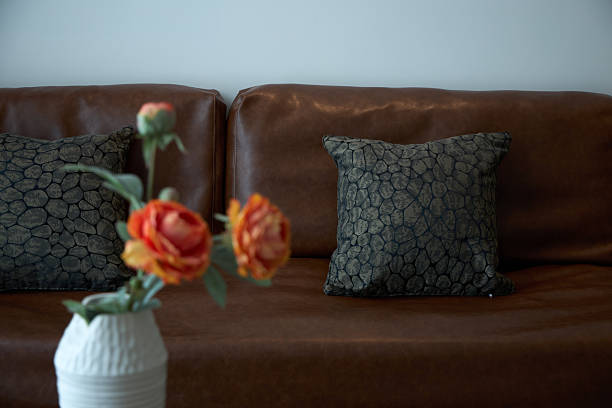 A vase in front of the leather sofa