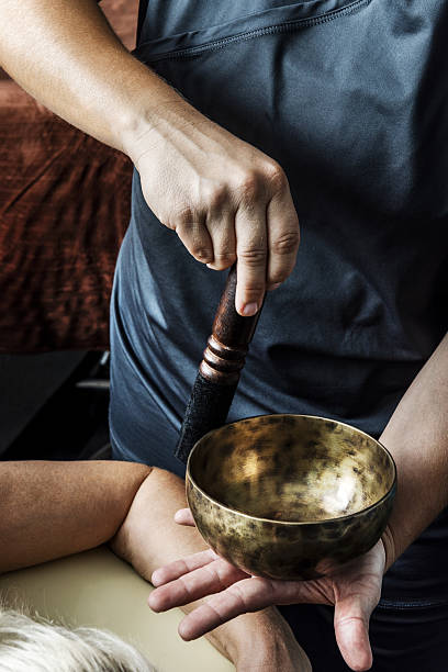istock A masseuse applying concentric force on a Tibetan bowl 2241979159