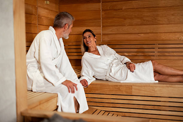 istock Mature couple relaxing and talking in sauna 2241980190