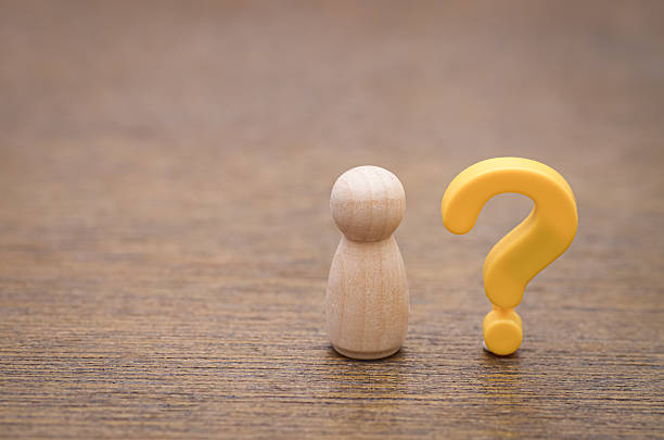 istock A simple wooden peg doll with a yellow question mark symbolizes the universal human experiences of doubt, personal identity, and the search for answers. 2241982130