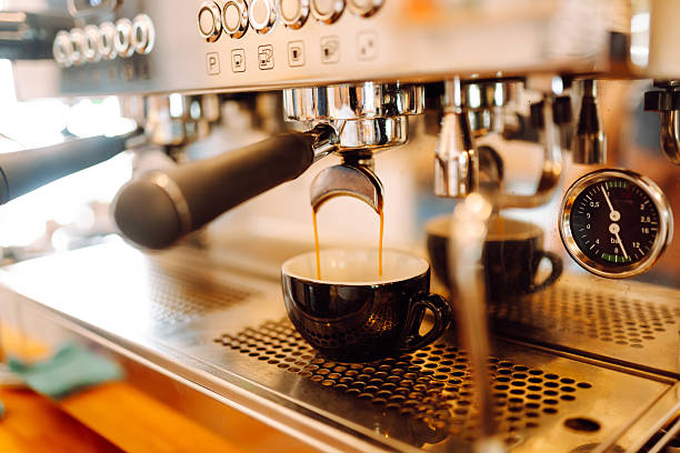 istock Experienced barista prepares freshly brewed coffee using professional coffee machine. 2241982583