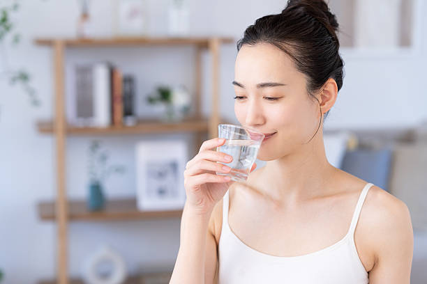 istock Young woman drinking water 2241982623