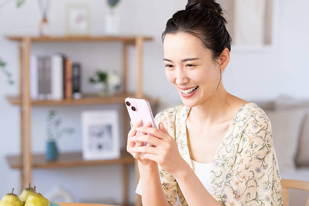 istock Young woman looking at smartphone at home 2241982933