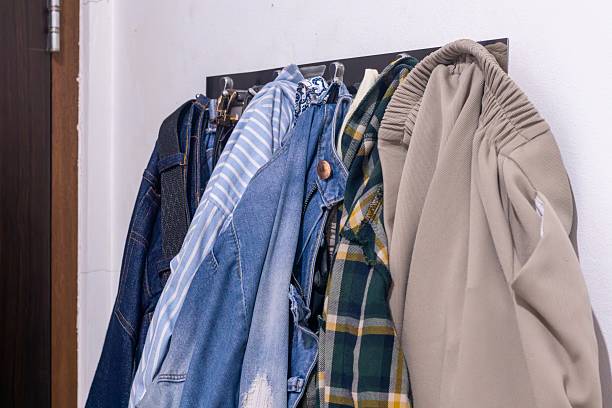 istock Clothes hanging on the wall at home 2241984294