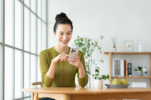 istock Young woman looking at smartphone at home 2241985210
