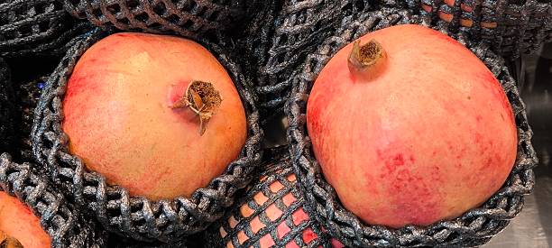 istock Red pomegranates in a fruit shop 2241988178