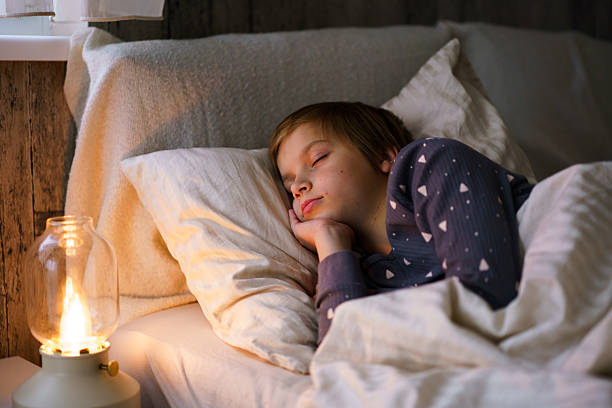 istock Little boy peacefully sleeping in bed at night 2241988936