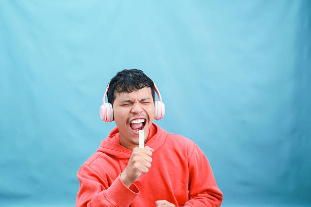 istock Man Singing Loudly with Headphones and Microphone. 2241989188