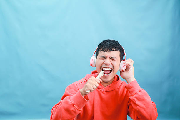 istock Man Singing with Headphones and a Microphone. 2241989195