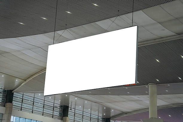 istock Blank advertising billboard hanging in the train station. Blank White Banners Hanging From Ceiling. Hangers Mockup Ready For Branding Or Advertising 2241990663