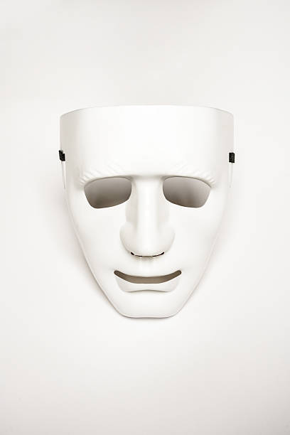 An expressionless mask of white color on a smooth white surface