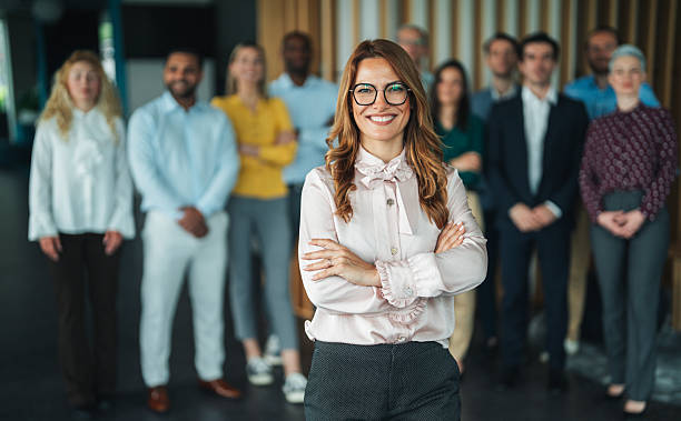 istock Empowered Business Leader Standing with Successful Team 2241992546