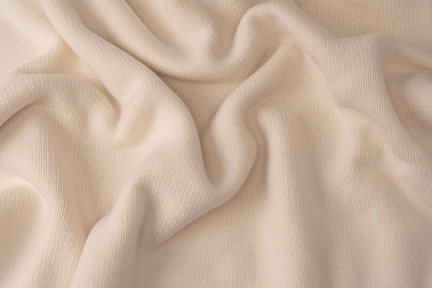 istock Soft milky color merino wool sweater texture as a background. 2241996709