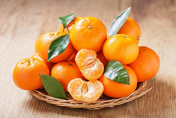istock Fresh mandarin oranges fruit or tangerines on a wooden table 2242000710
