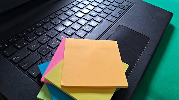 istock Laptop and Colorful Sticky Notes on Green Desk 2242001343