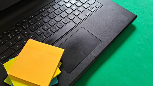 istock Laptop and Colorful Sticky Notes on Green Desk 2242001352