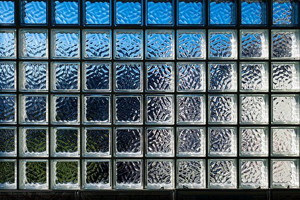 istock A block glass window reflecting the blue sky on a clear day, 2242002572