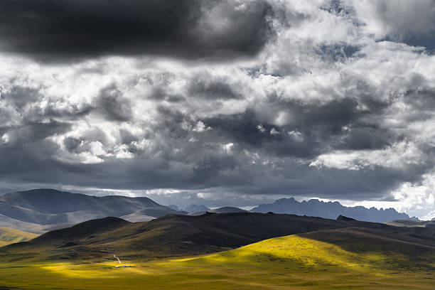 istock Dramatic Storm Clouds Over Golden Rolling Hills in Mountain Landscape 2242003073