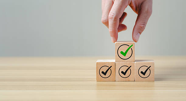 istock Checklist and quality assurance concept with wooden blocks stacked with check mark icons, symbolizing task completion, project approval, business standard, successful evaluation, process verification 2242004802