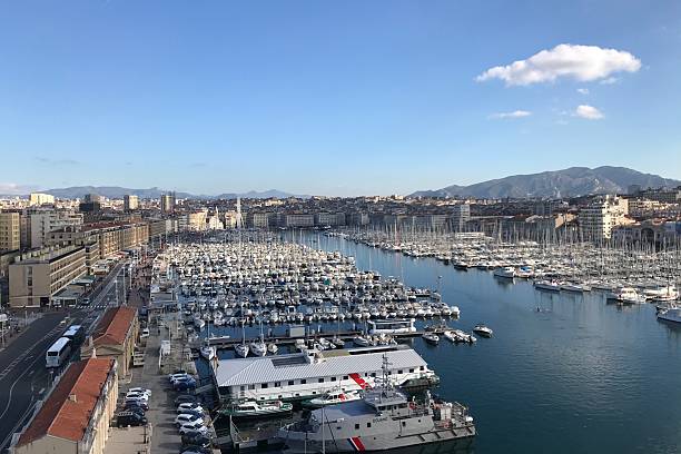 The old port of Marseille with its numerous boats and incredible architecture. Beautiful blue sky.